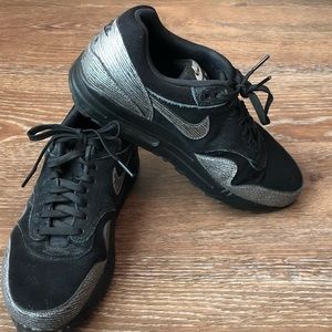 Nike custom designed black cross training shoe.